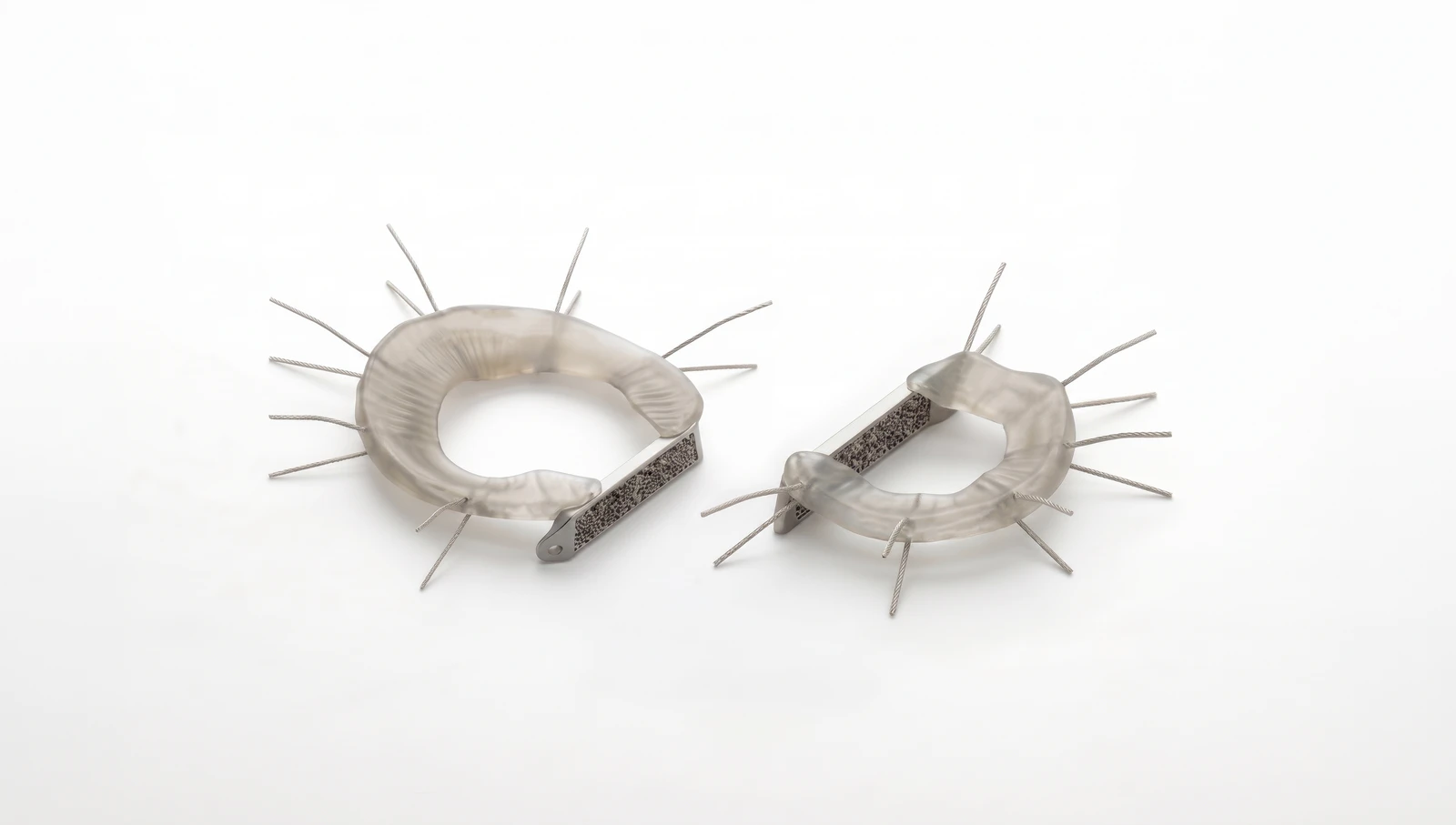 Two LunaFlex implants side by side, one configured for the medial meniscus and one for the lateral, each with peripheral suture strands and a fixation bridge.